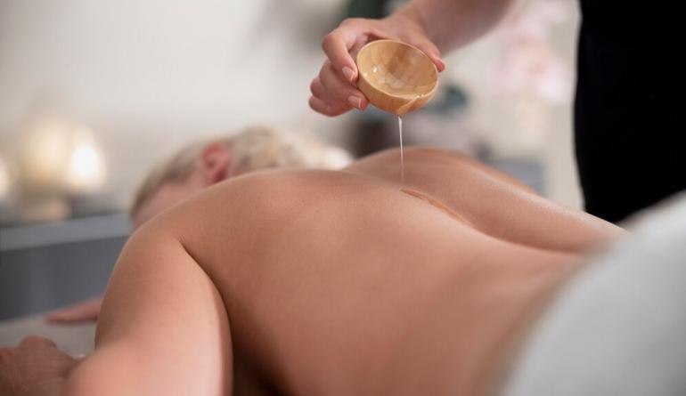 young-woman-using-massage-oil-her-client23-2149037160.jpg